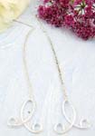 Sterling silver stud earring with long chain holding a flower twisted pattern on bottom